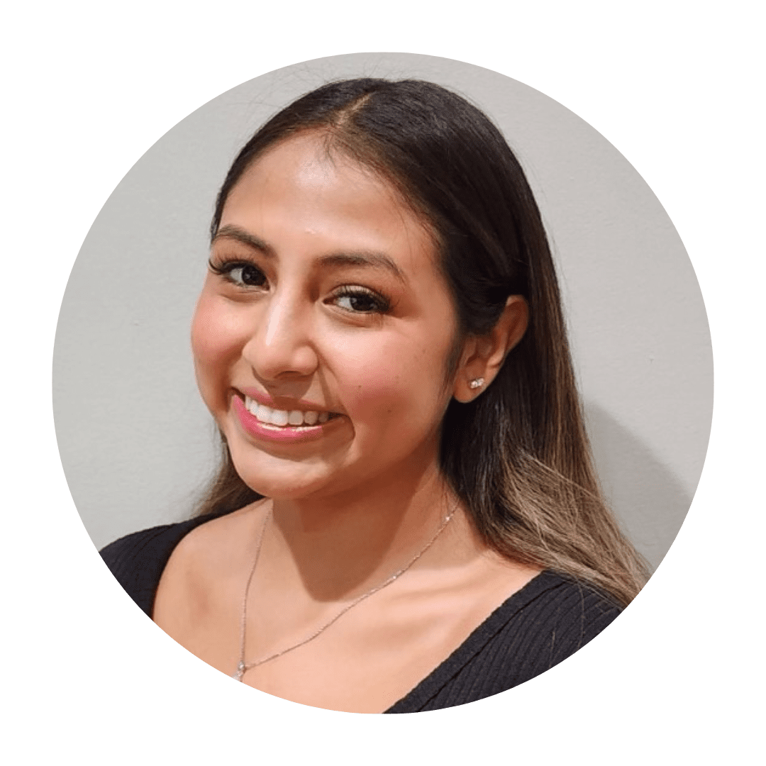 A beautiful woman smiling with ear tops and a necklace